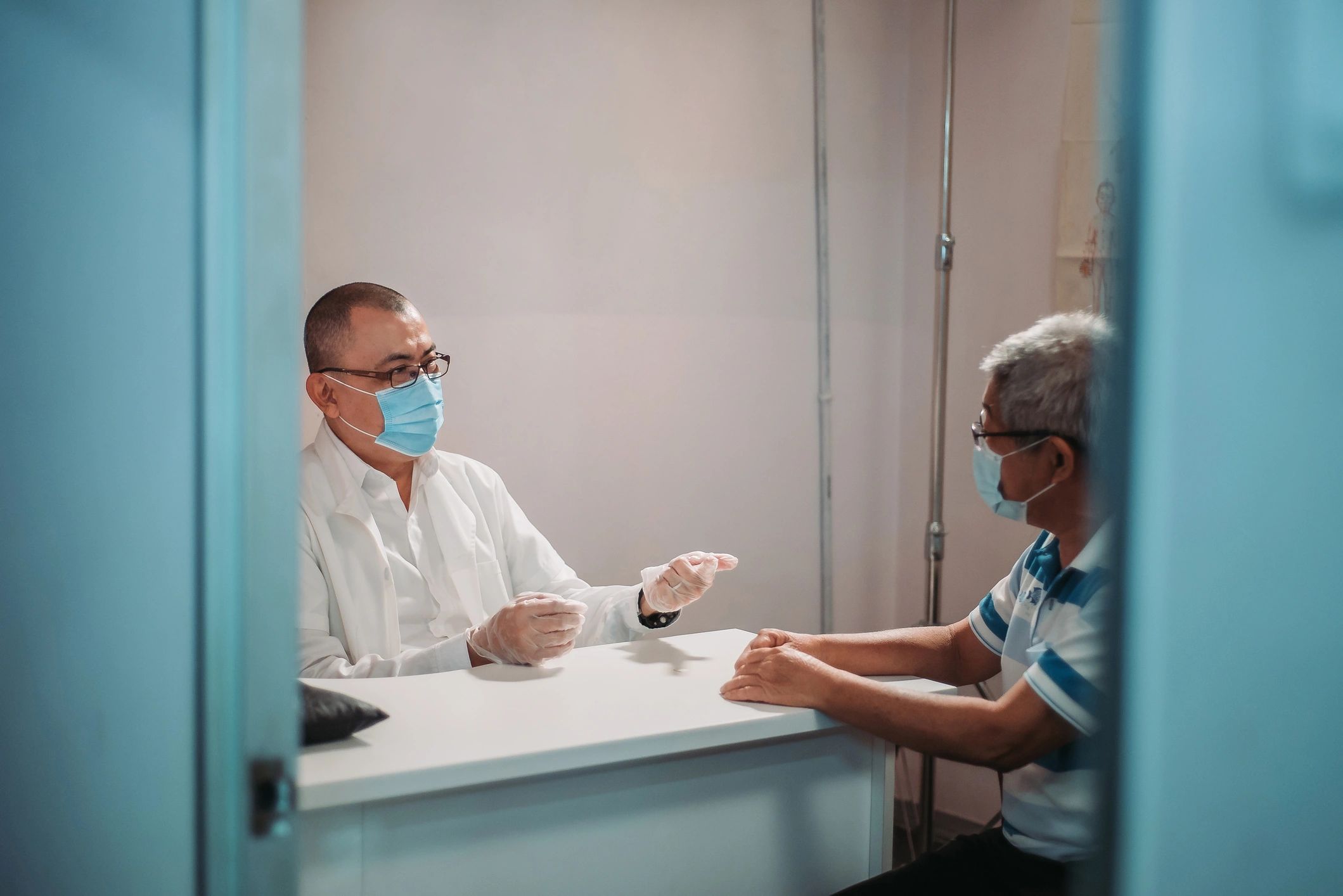 Doctor speaking with an older patient in a clinic